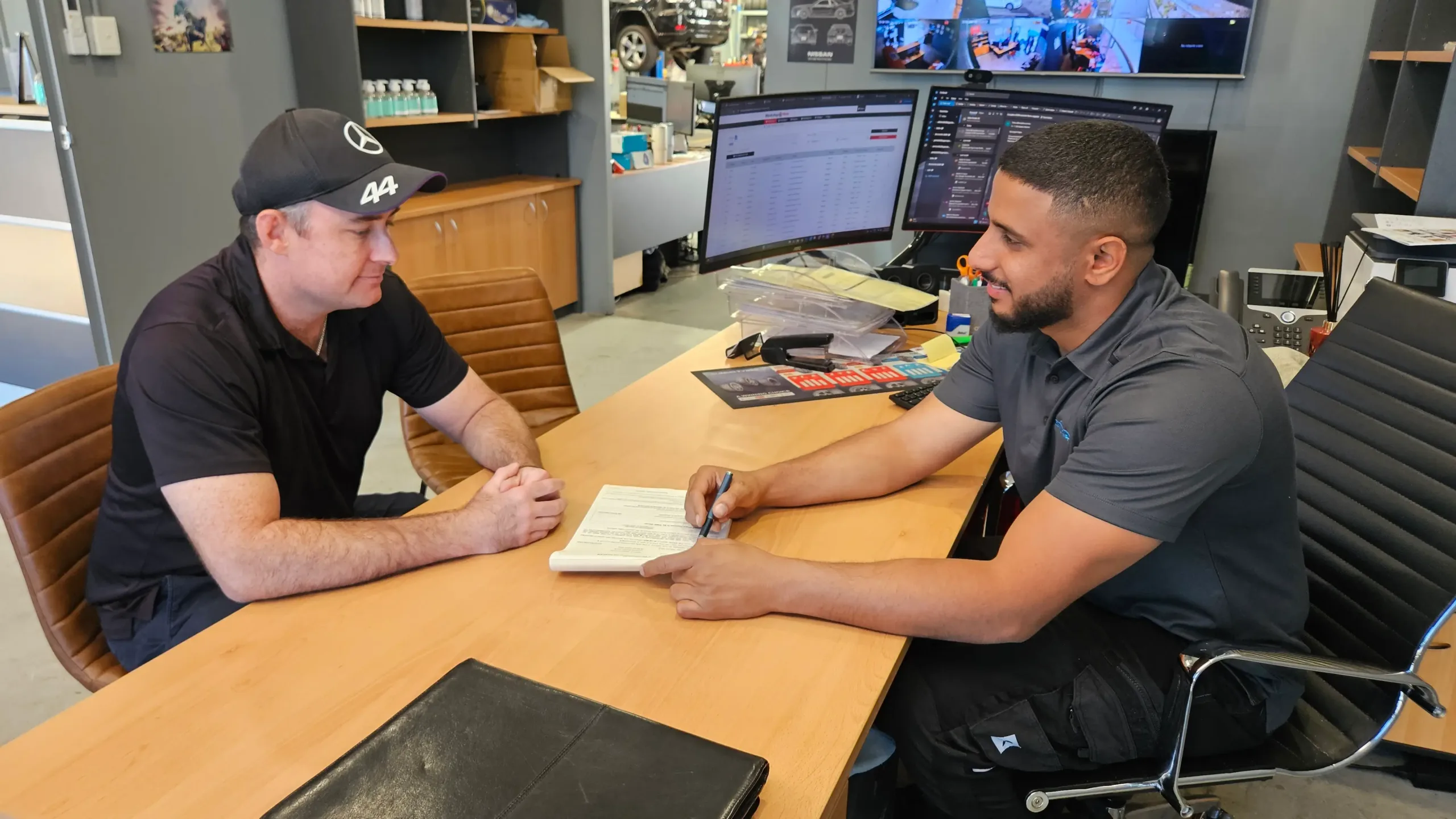 Sell My Car Pro buyer finalising a sale with a business owner