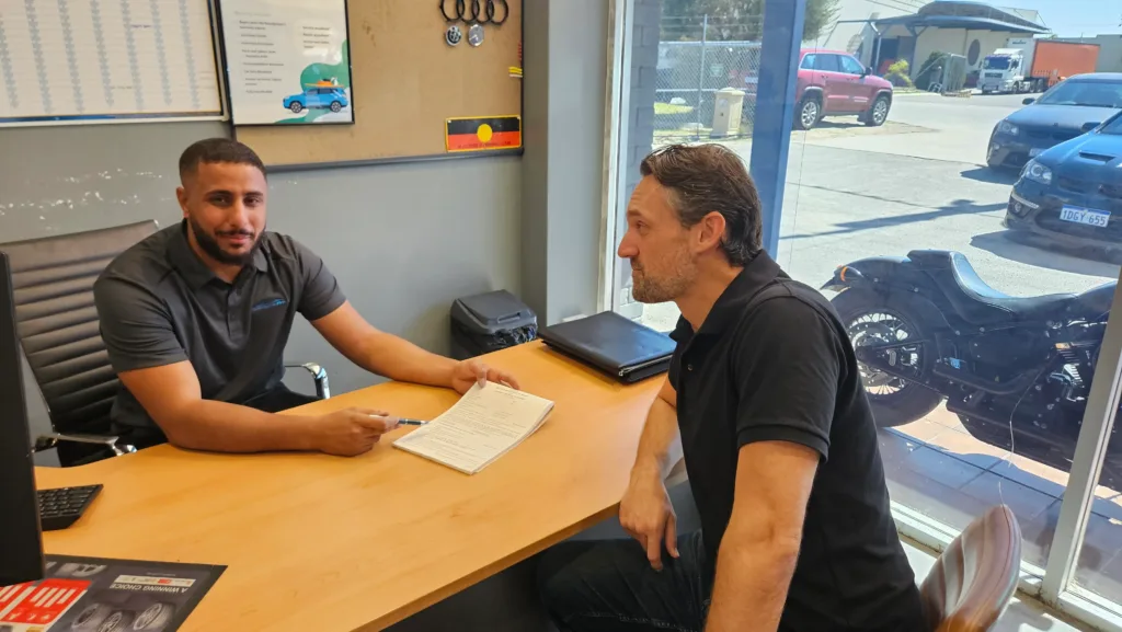 Sell My Car Pro buyer completing a purchase agreement with a seller