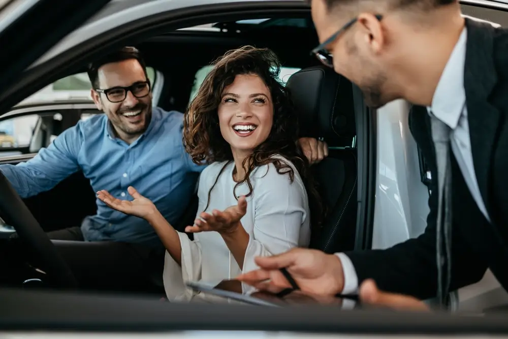 Middle age couple choosing and buying car at a Dealership