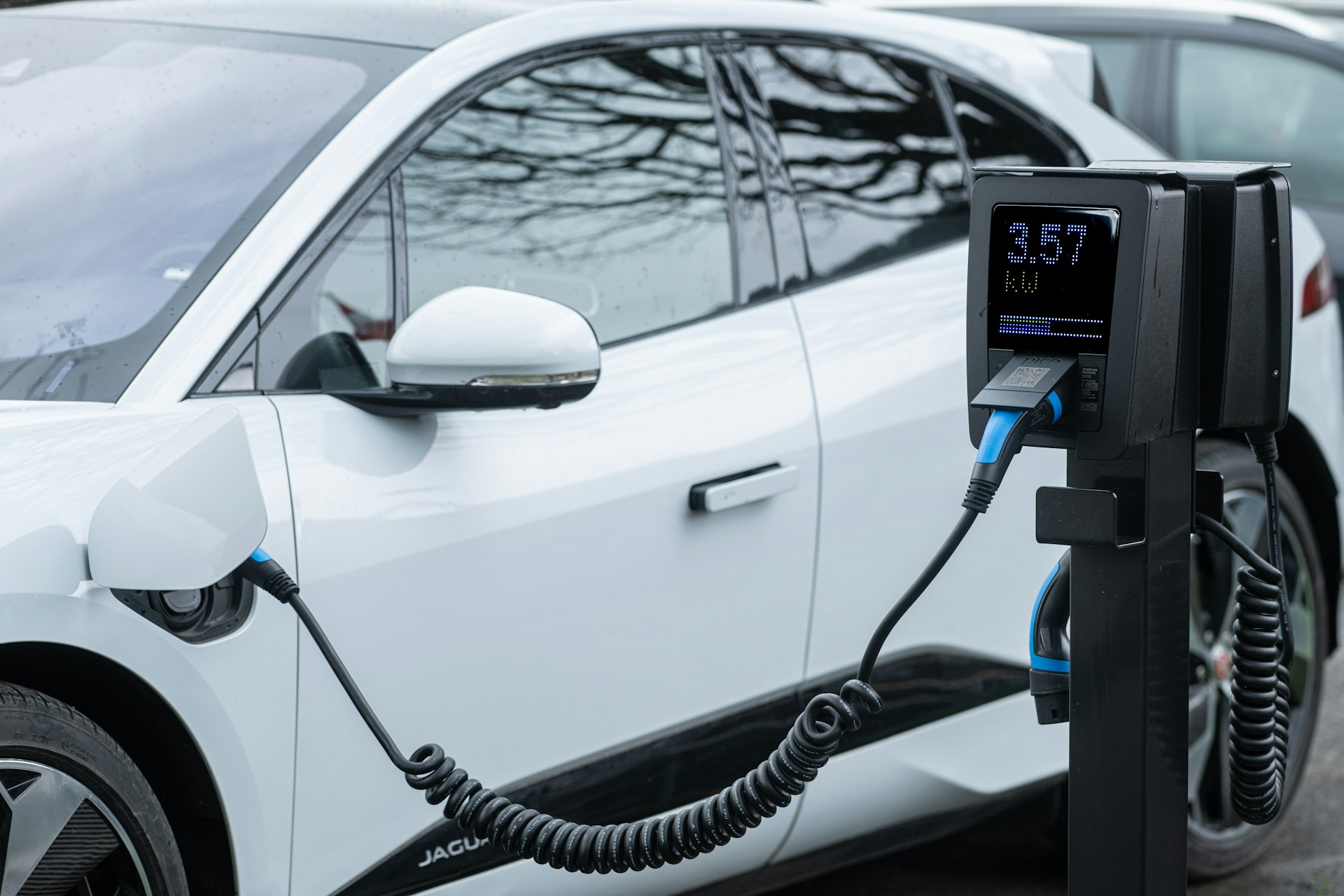 a white electric vehicle charging up